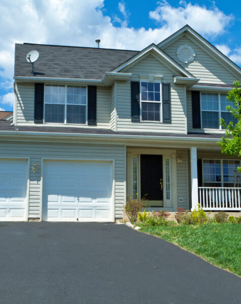 Single family house in suburban Maryland, United States.  Two car garage, driveway and basketball hoop.